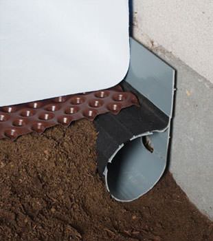Closeup of a crawl space drainage system installed in Richmond
