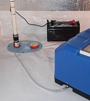 Closeup of a crawl space sump pump installed in Oakland